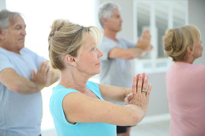 Group of senior people doing fitness exercises in gym