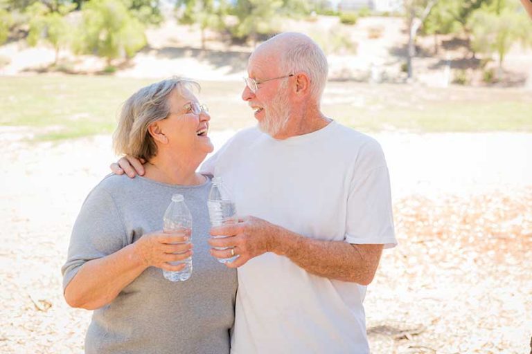 Happy Healthy Senior Couple with Water Bottles