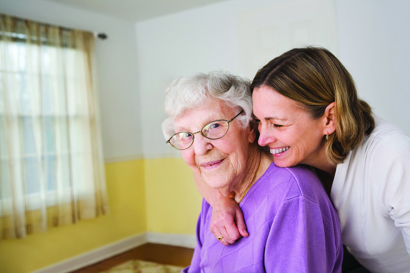 Daughter hugging Elderly mother