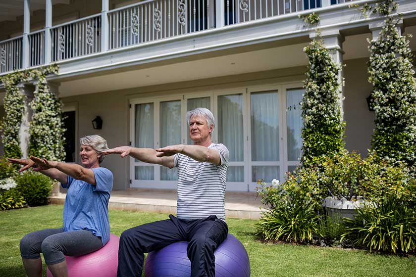 Couple exercising on fitness ball