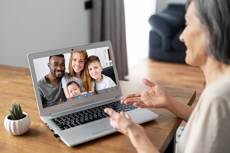 Senior woman talking on the laptop online