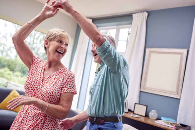 Romantic Senior Retired Couple Dancing In Lounge At Home Togethe Romantic Senior Retired Couple Dancing In Lounge At Home Togethe