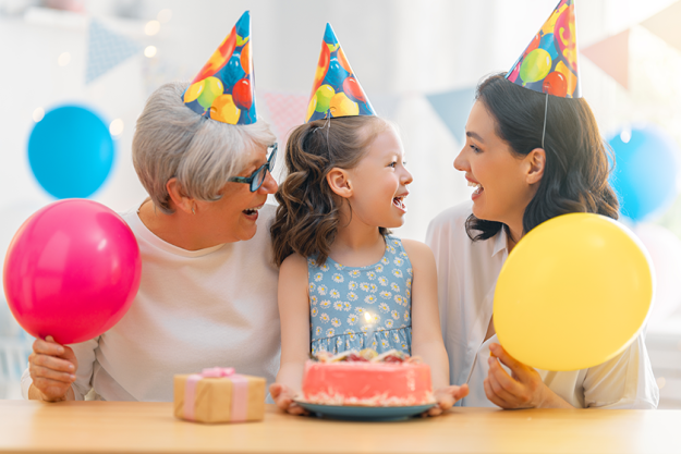 kid-blowing-out-candles-cake-grandmother-mother-daughter kid-blowing-out-candles-cake-grandmother-mother-daughter