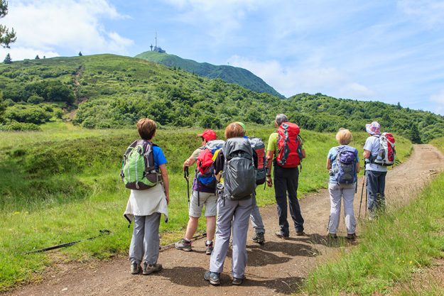Group of hikers walking on a path Group of hikers walking on a path