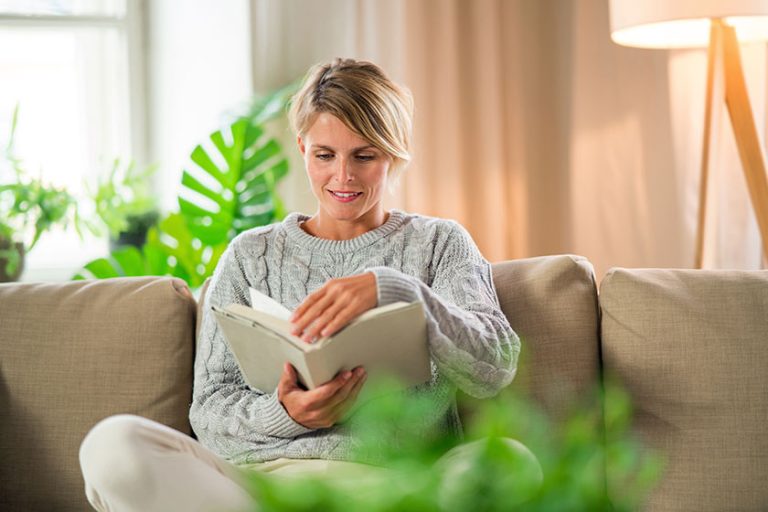 Portrait of woman relaxing with book