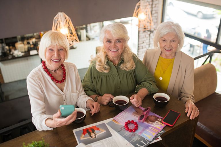 Women looking cheerful while sitting at the table