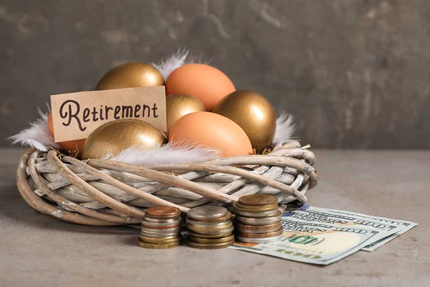 Different eggs, money and card with word Retirement