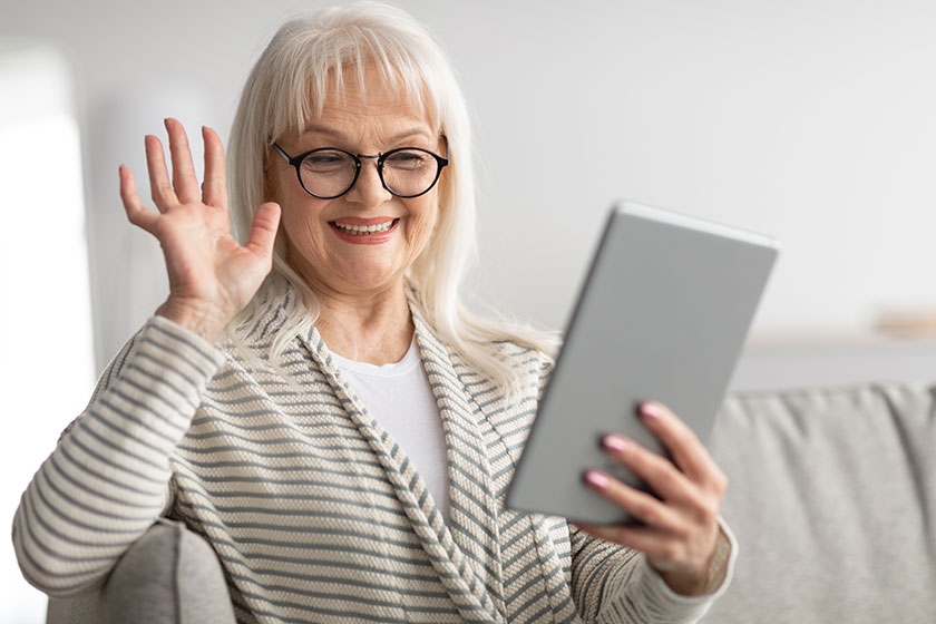 Happy woman using tablet for video call Happy woman using tablet for video call
