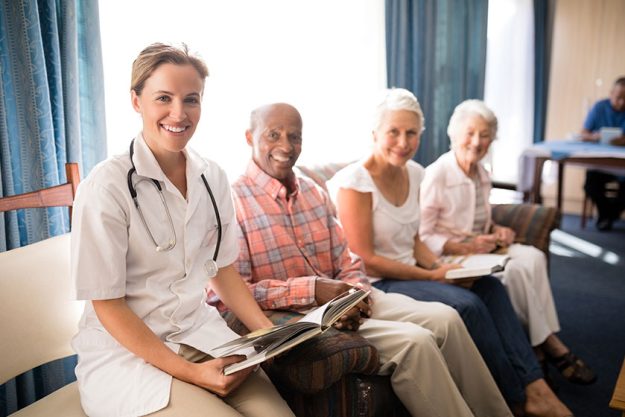 Female doctor sitting with senior man and women Female doctor sitting with senior man and women