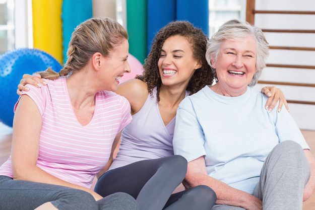 Female friends sitting in gym Female friends sitting in gym