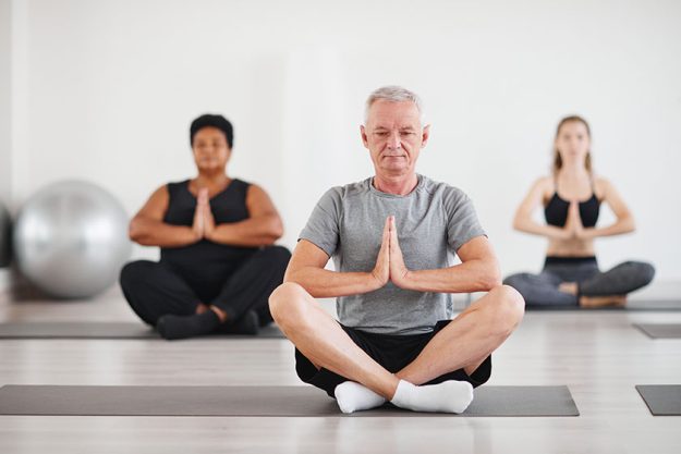 Senior people doing meditation in class Senior people doing meditation in class