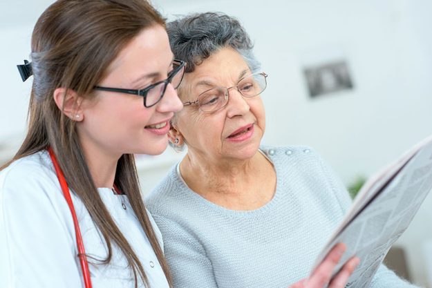 Doctor reading to a patient Doctor reading to a patient