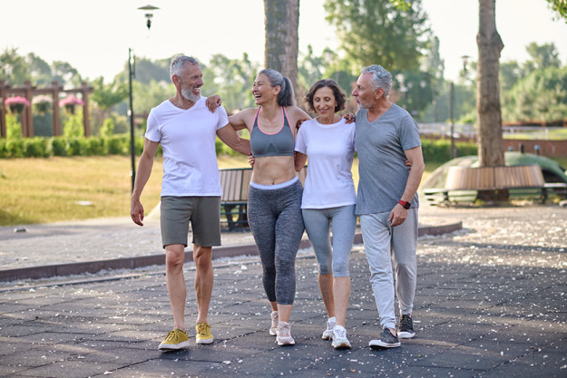 active-mature-people-standing-together-park-hugging
