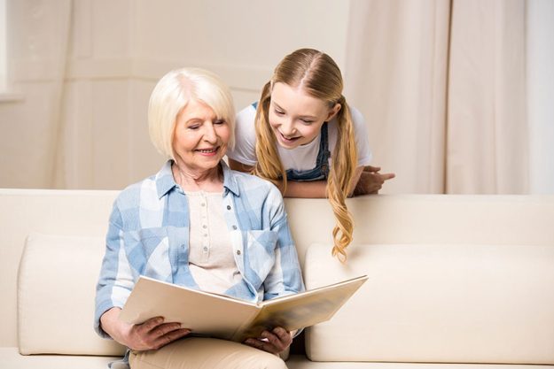 Grandmother and girl with photo album
