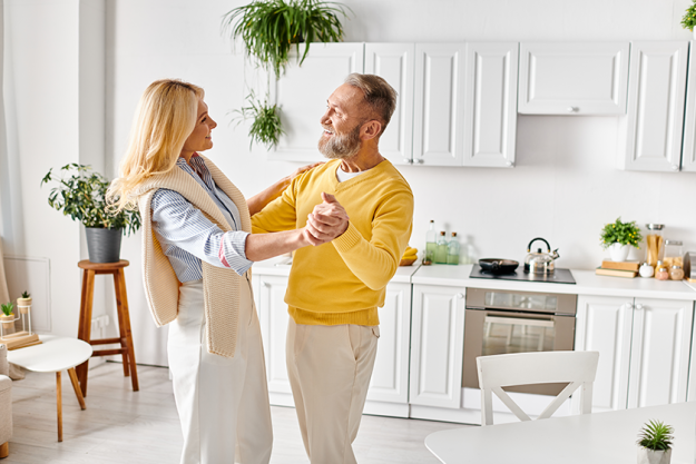 mature-loving-couple-clad-cozy-homewear-joyfully-dancing-together mature-loving-couple-clad-cozy-homewear-joyfully-dancing-together