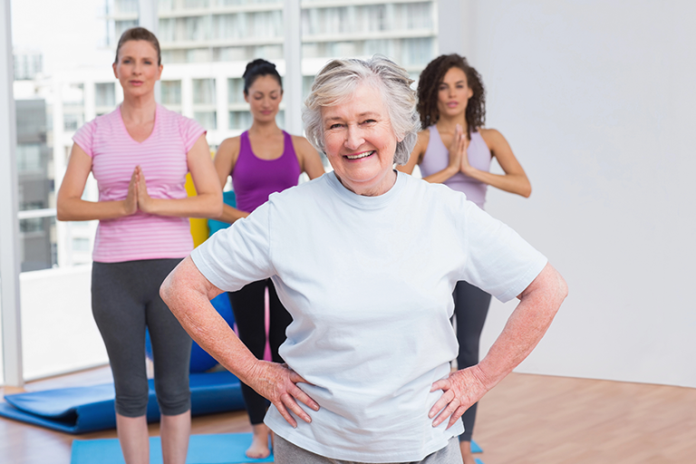 senior-woman-with-hands-on-hip-standing-in-gym
