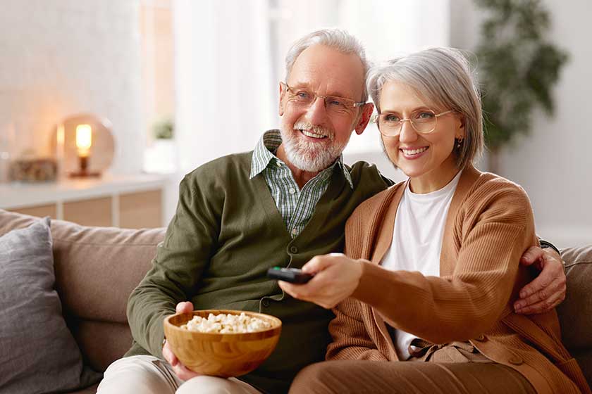 Beautiful-happy-senior-couple-husband-and-wife-eating-popcorn