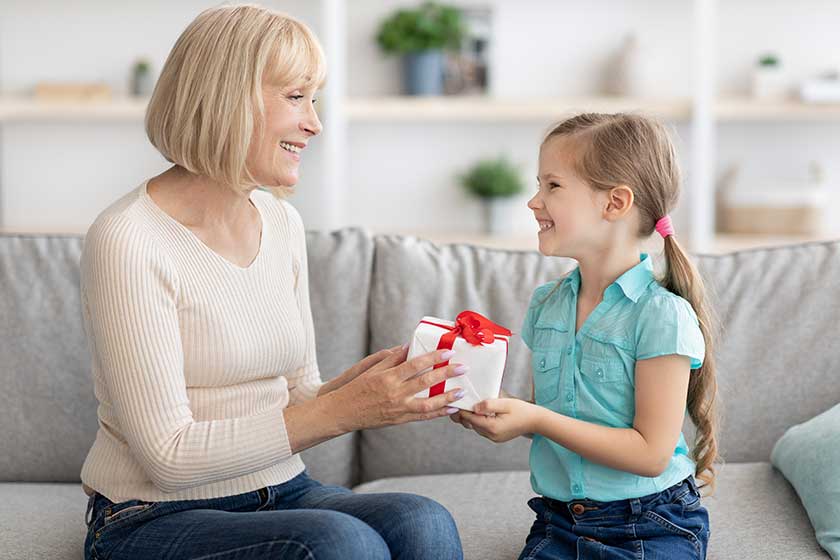 Little-girl-greeting-mature-lady-giving-box