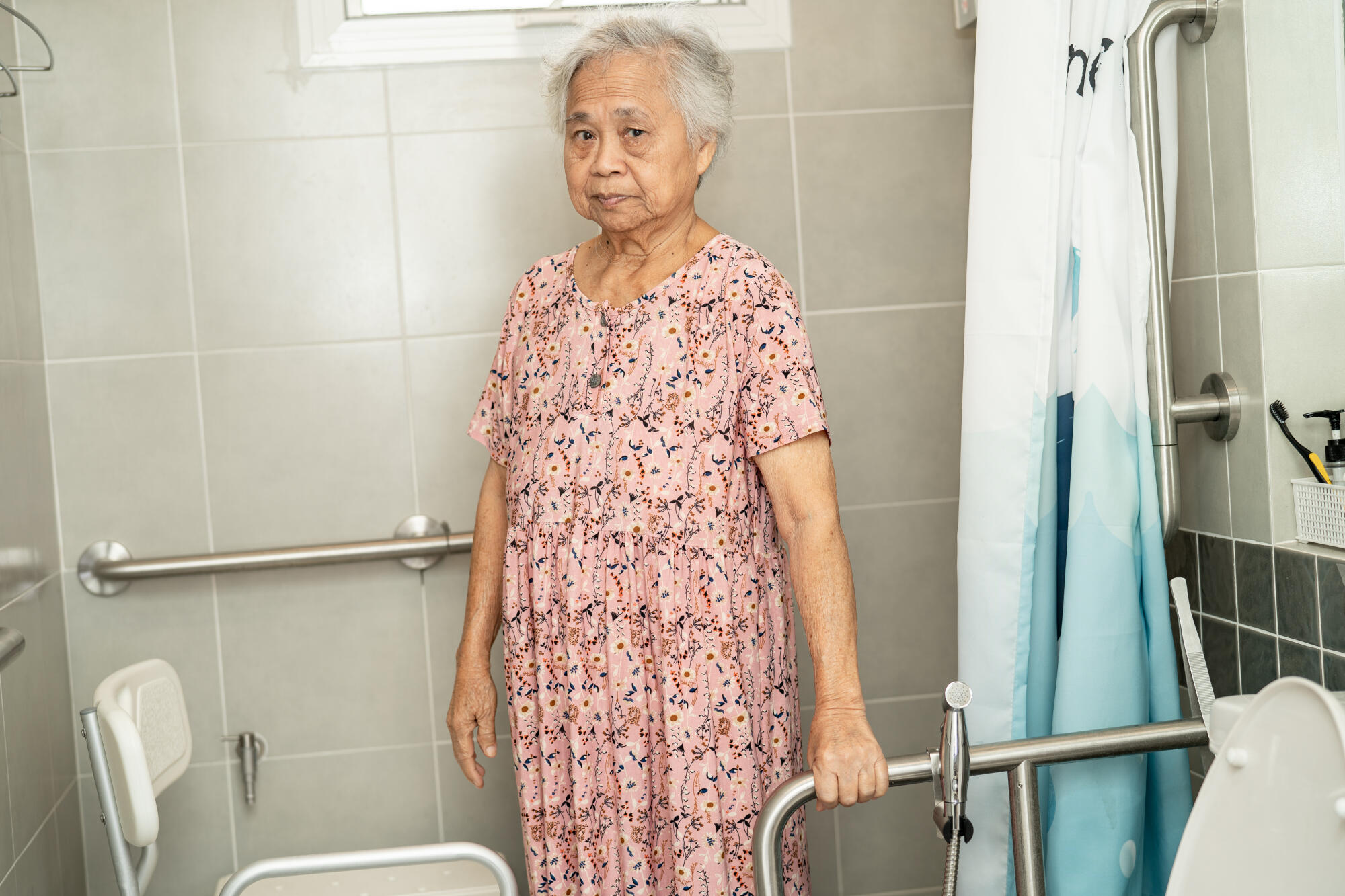 Asian elderly woman patient use toilet bathroom handle security