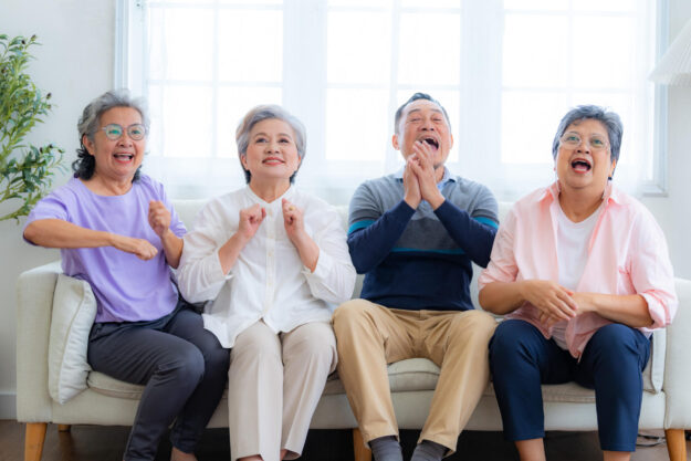 Happiness of the group females and male elderly sitting on the s