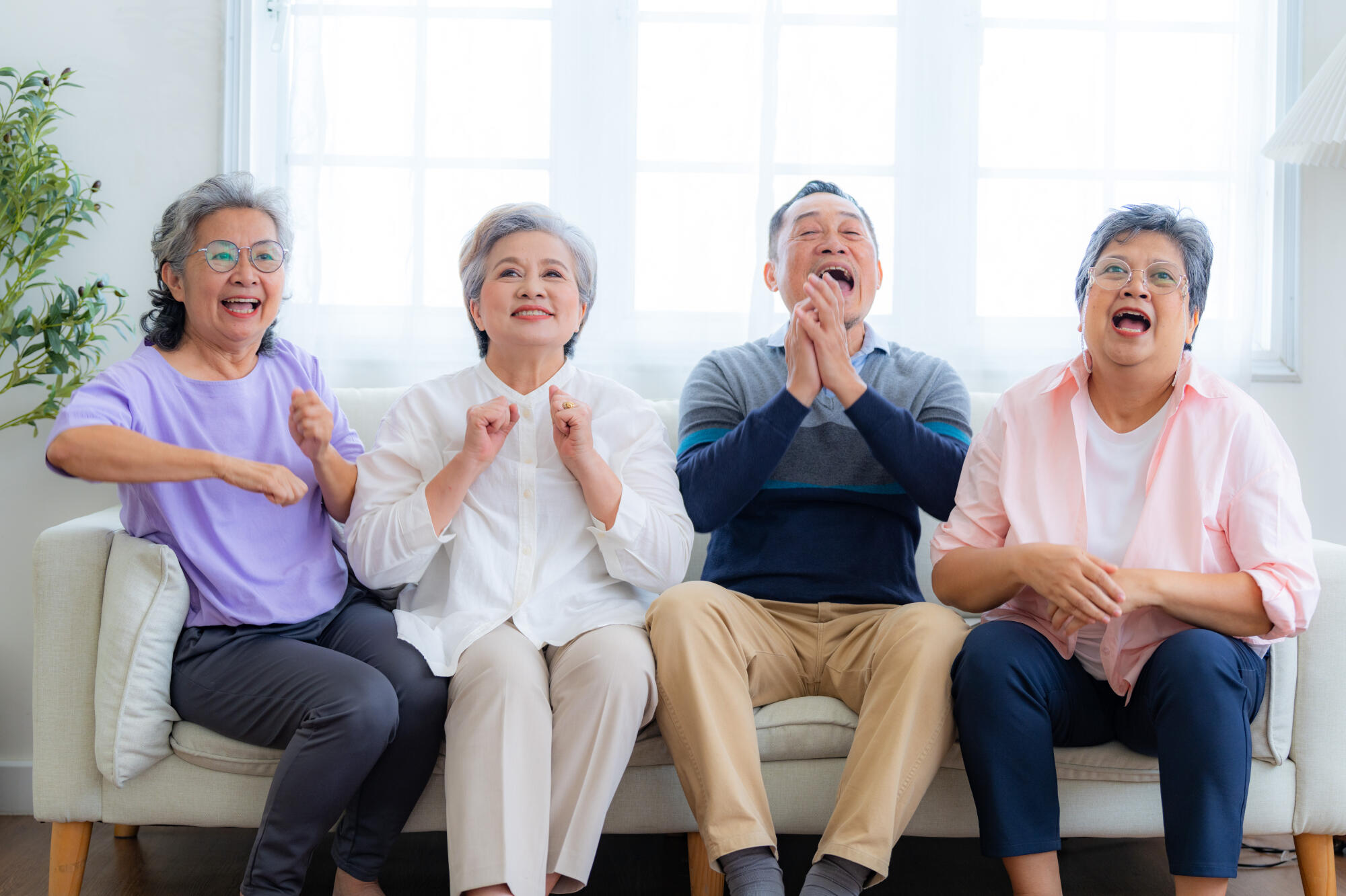 Happiness of the group females and male elderly sitting on the s