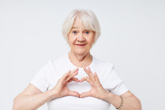 emotional elderly woman in a white t-shirt cropped view